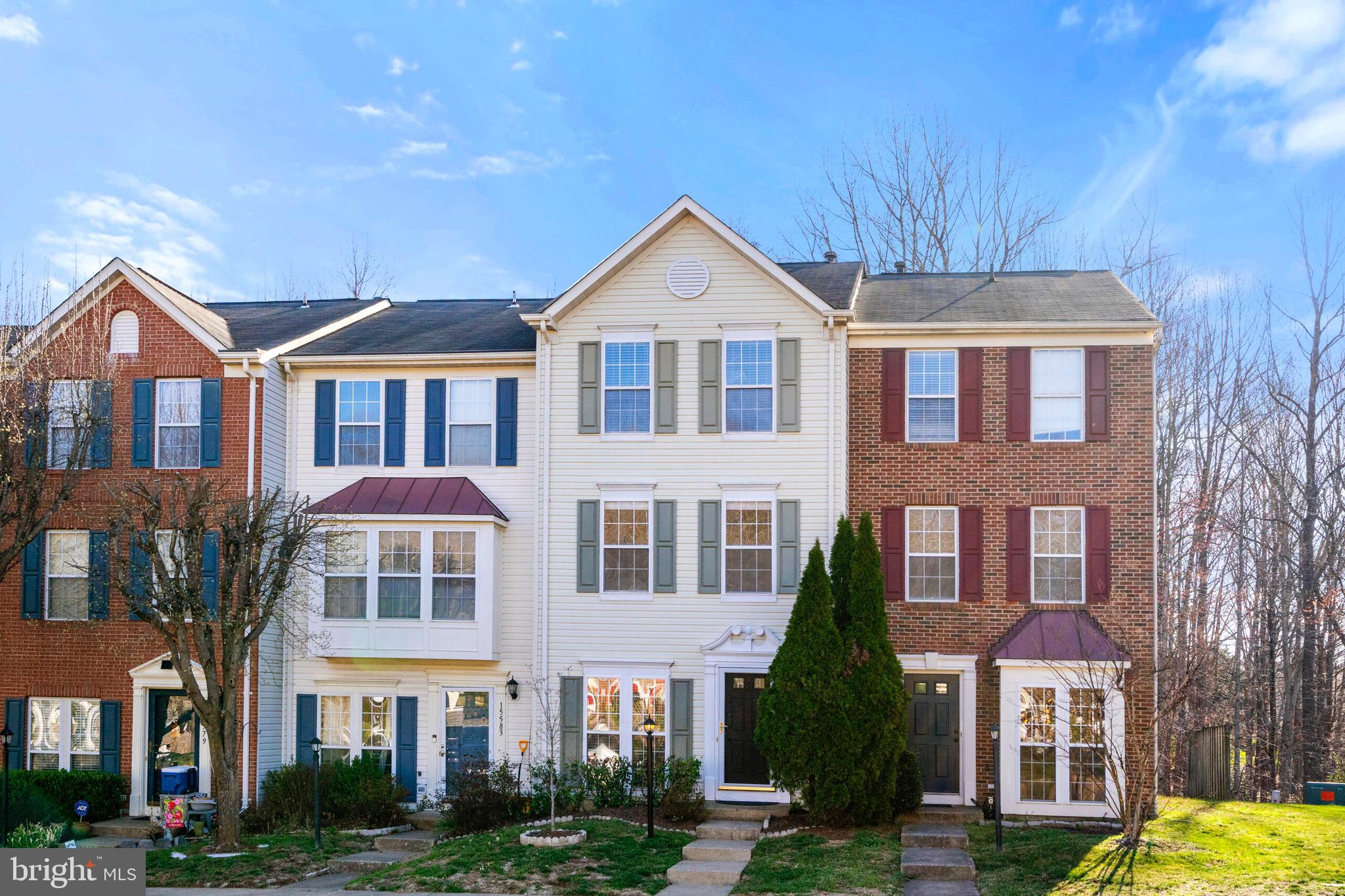 15587 Three Otters Place Manassas, VA 20112 - Photo 1 of 27 a front view of a residential apartment building with a yard