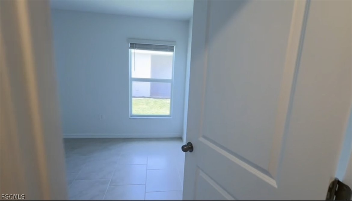 12312 Amber Waves Road Lehigh Acres, FL 33974 - Photo 12 of 33 a view of an empty room and a window