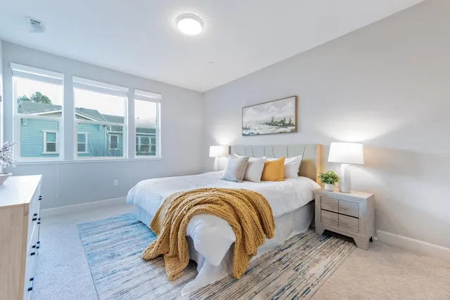 a bedroom with bed and a night stand