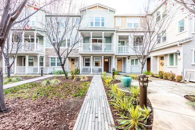 a view of a brick building next to a yard