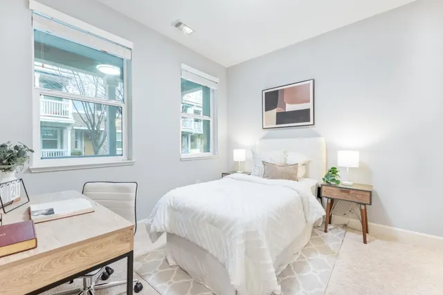 a bedroom with a bed and a painting on the wall