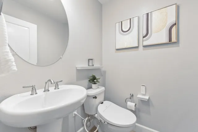 a bathroom with a shower sink and mirror