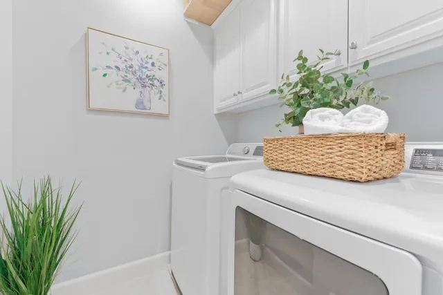 a view of a kitchen with white cabinets
