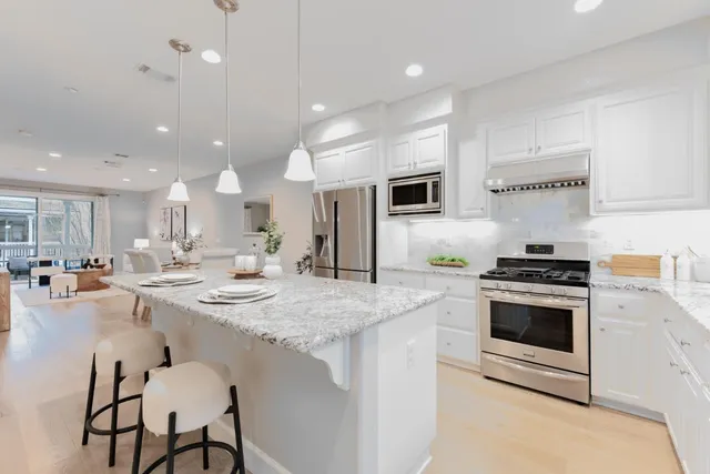 a kitchen with a stove a sink and a refrigerator