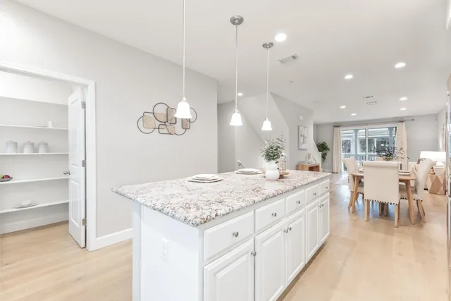 a large kitchen with a table and chairs