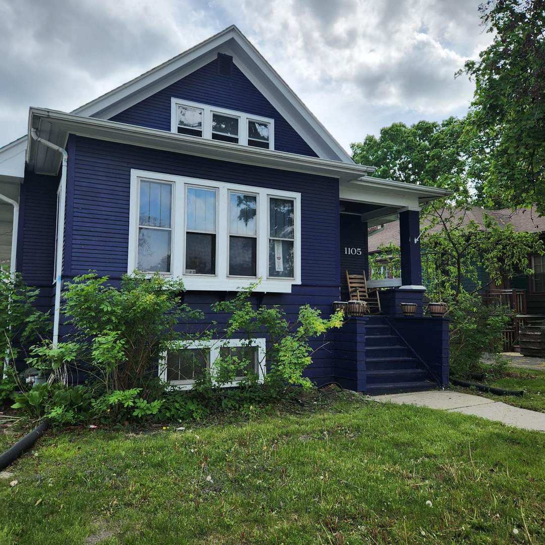1105 West Touhy Avenue, Unit 2 Park Ridge, IL 60068 - Photo 2 of 2 a front view of a house with a yard