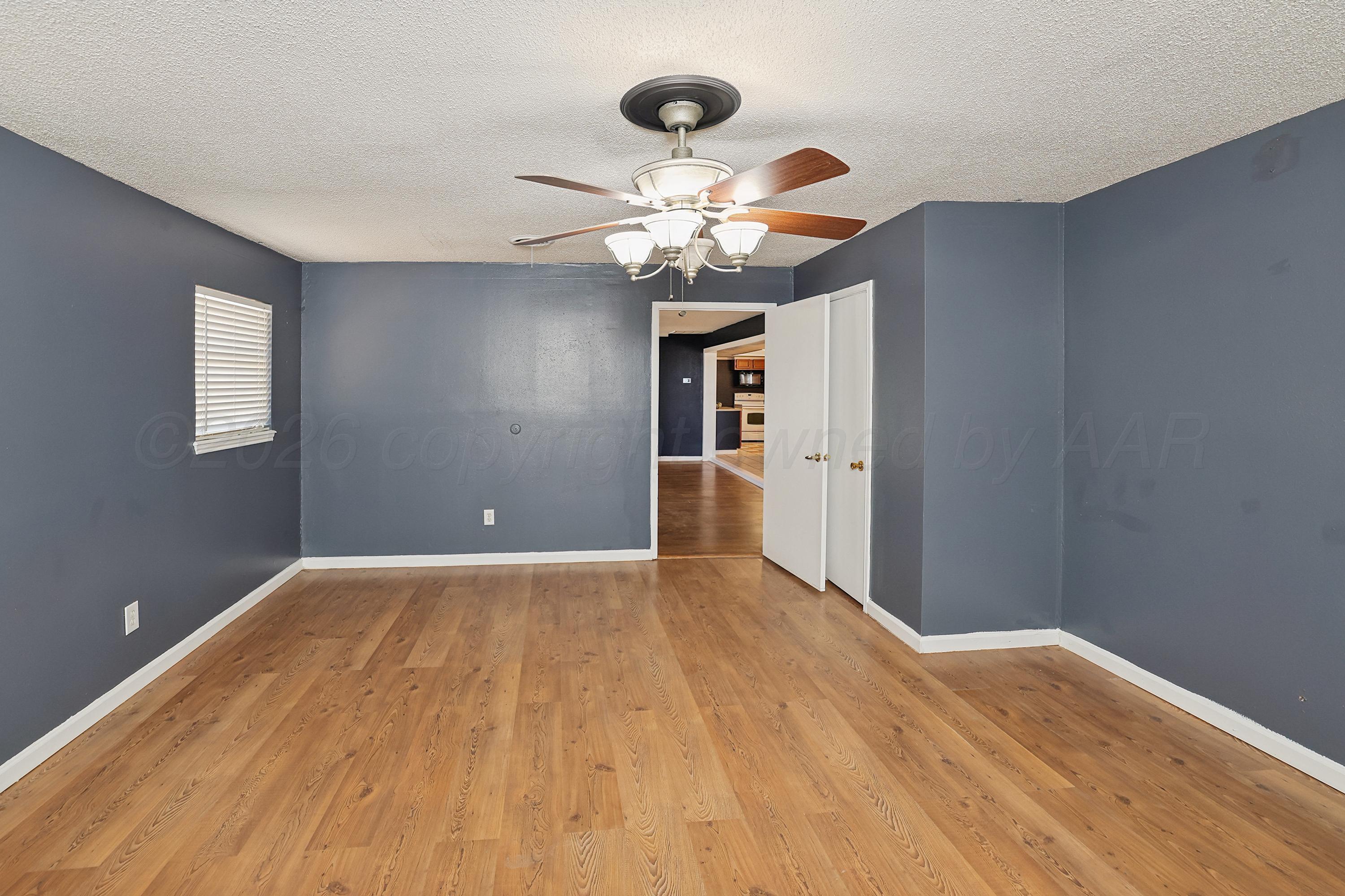 14200 Savannah Road Amarillo, TX 79118 - Photo 20 of 34 a view of an empty room with window and wooden floor