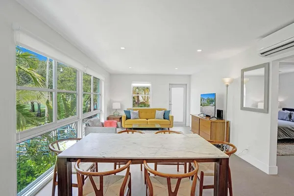 a dining room with large window table and chairs