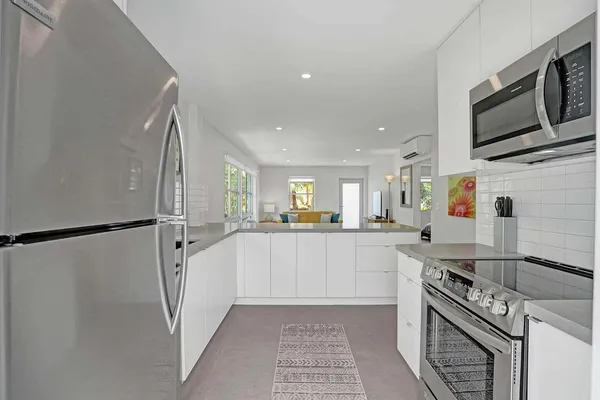 a kitchen with stainless steel appliances a refrigerator sink and microwave