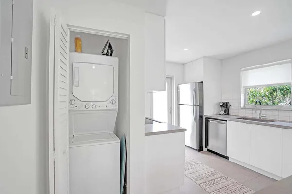 a kitchen with a refrigerator sink and cabinets