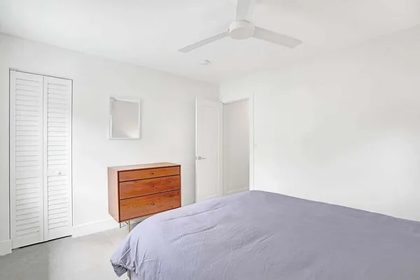 a bedroom with a bed and cabinets