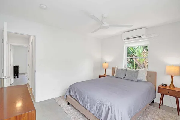 a bedroom with a bed and a lamp with window