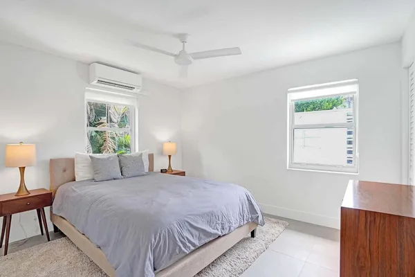 a bedroom with a bed lamps and window