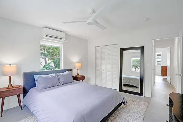 a bedroom with bed and window
