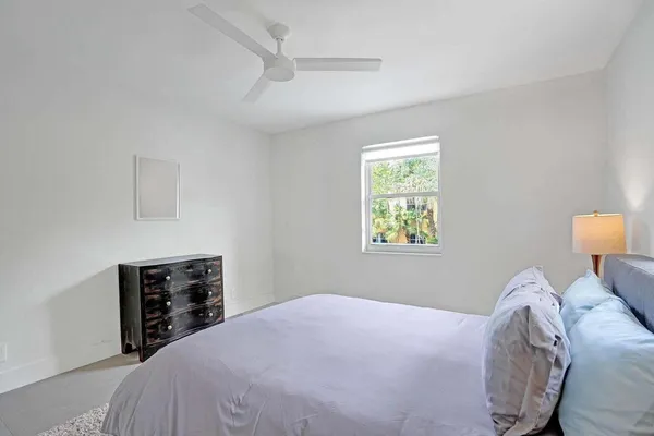 a bedroom with a bed and a tv
