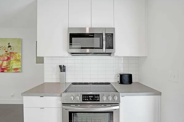 a stove top oven sitting inside of a kitchen