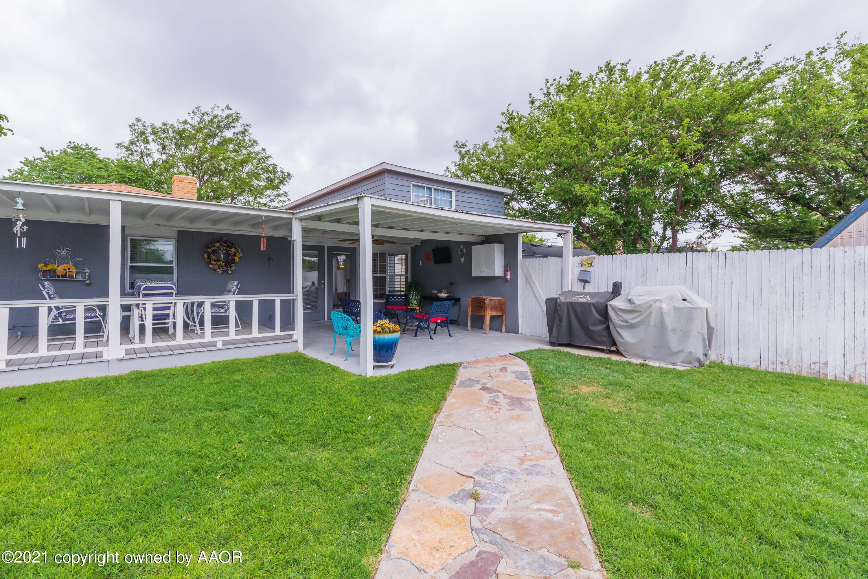 4707 Journey Street Amarillo, TX 79110 - Photo 11 of 65 a view of a patio with table and chairs potted plants and large tree