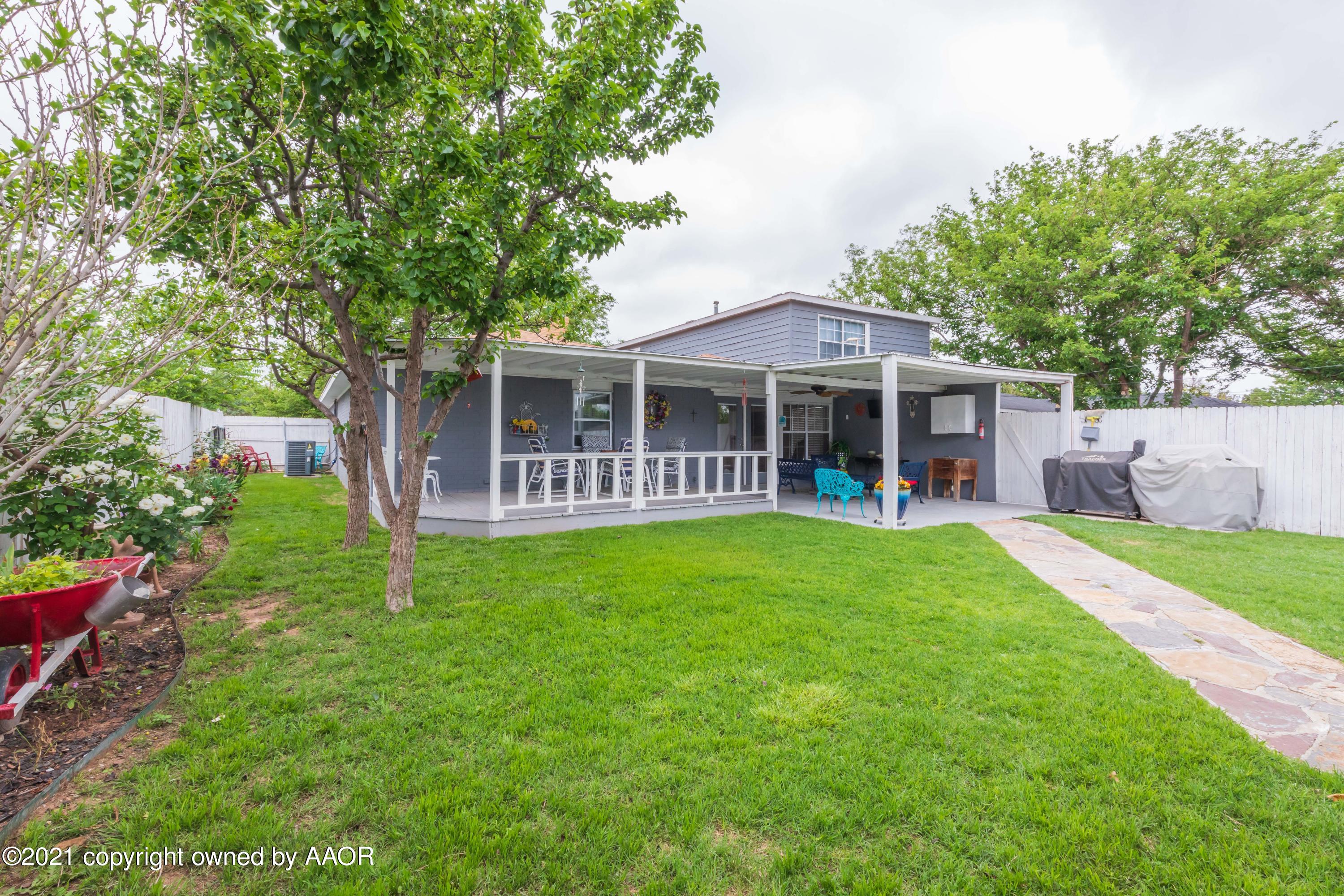 4707 Journey Street Amarillo, TX 79110 - Photo 12 of 65 a view of a house with a yard deck and a large tree