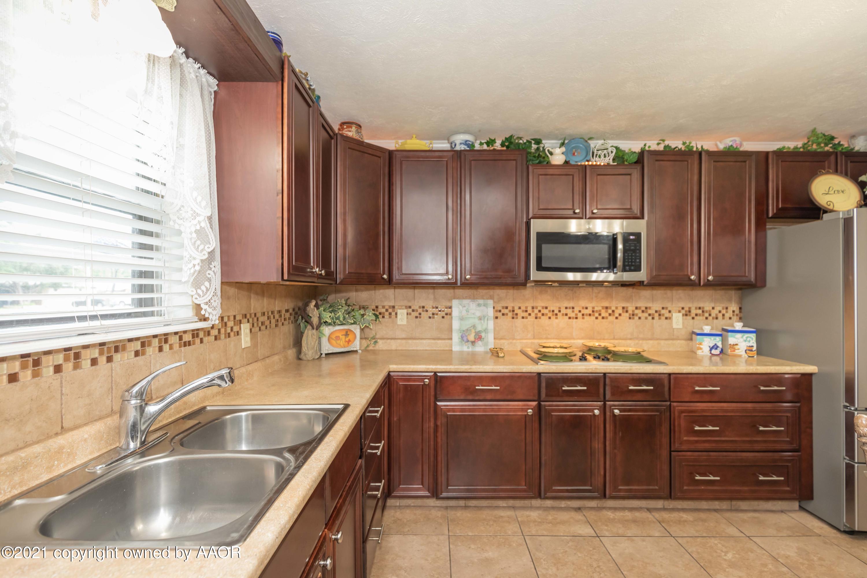 4707 Journey Street Amarillo, TX 79110 - Photo 15 of 65 a kitchen with a sink and cabinets