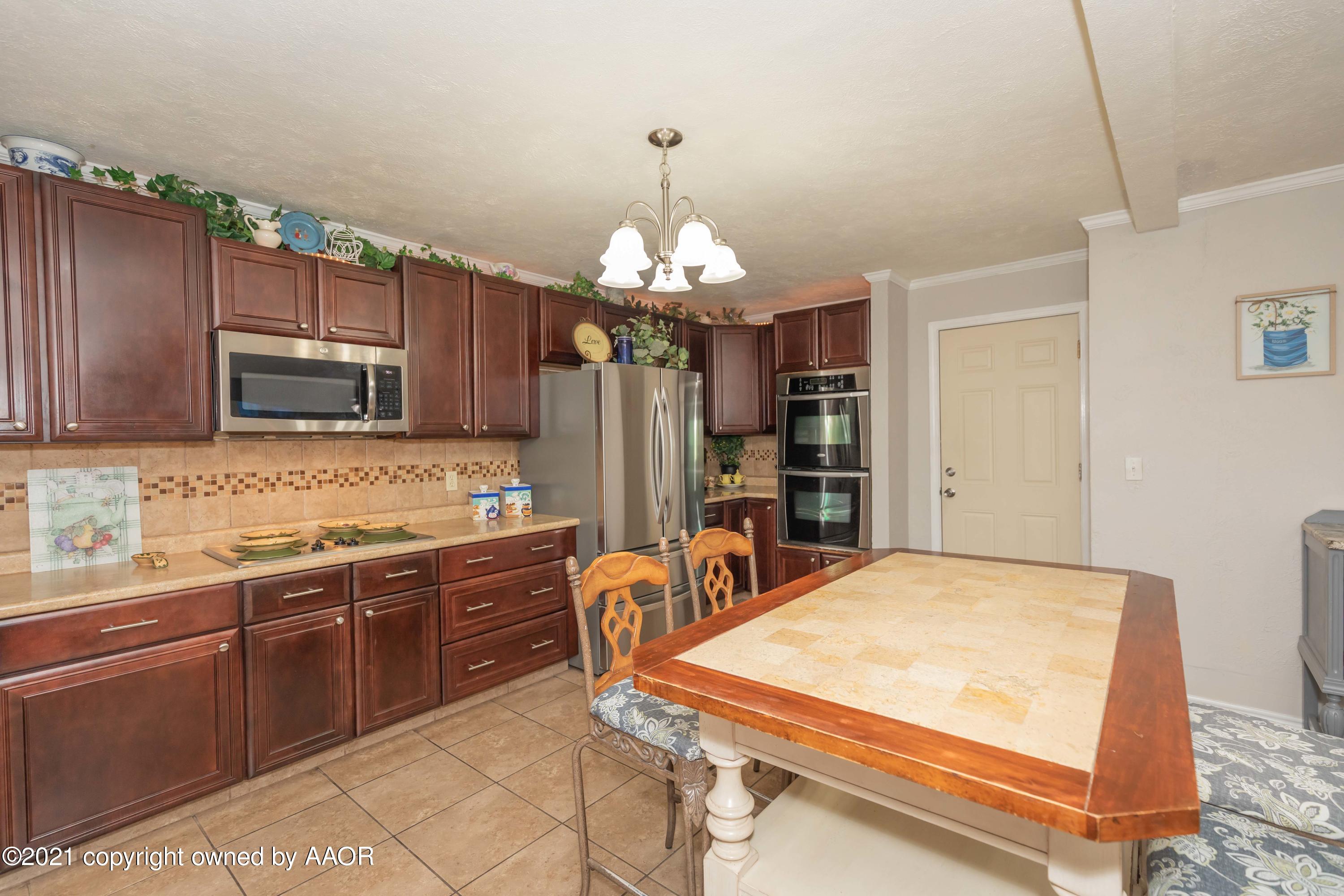 4707 Journey Street Amarillo, TX 79110 - Photo 16 of 65 a kitchen with stainless steel appliances a sink stove and refrigerator