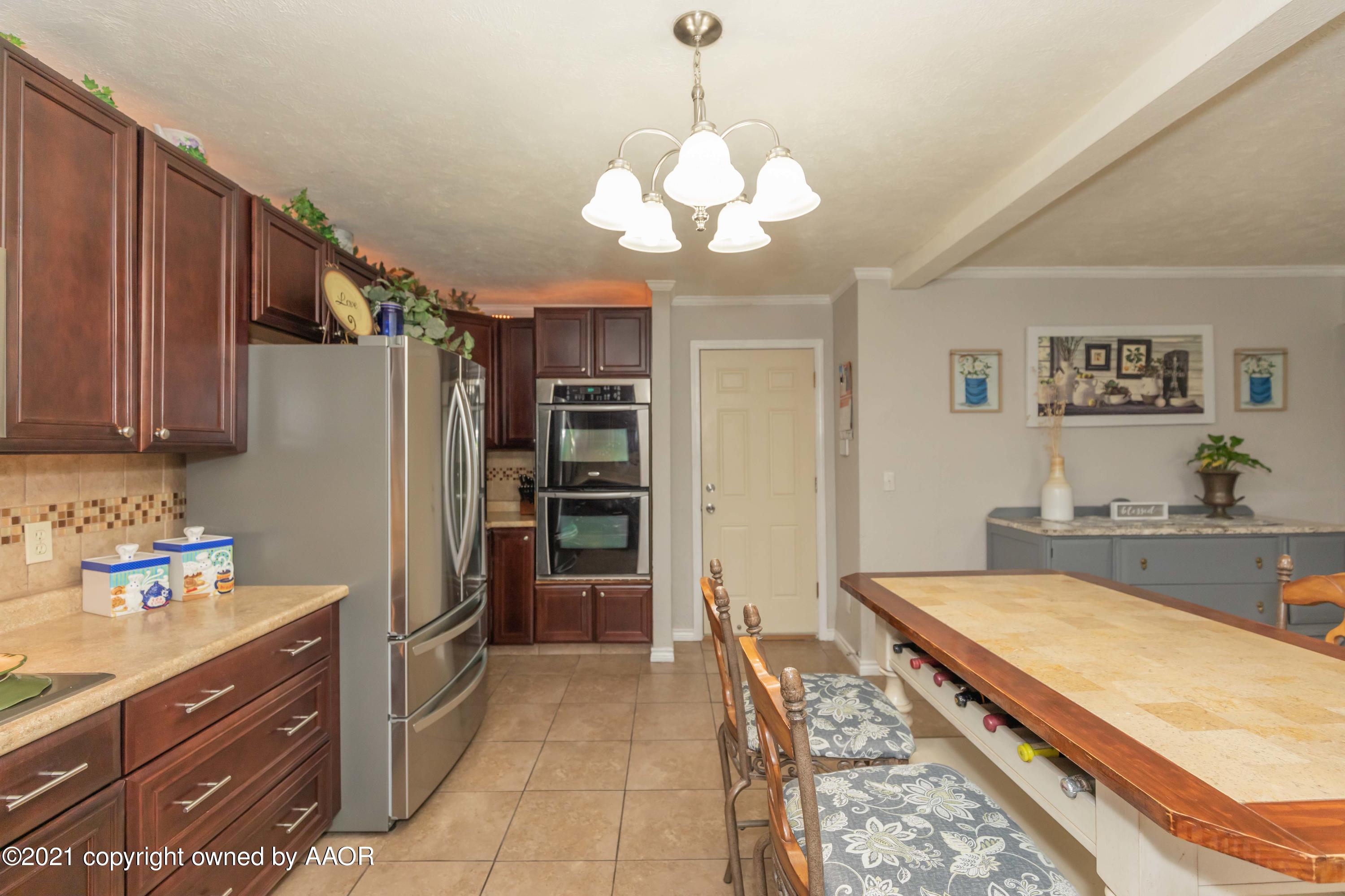 4707 Journey Street Amarillo, TX 79110 - Photo 17 of 65 a kitchen with stainless steel appliances granite countertop a refrigerator a sink dishwasher stove and oven