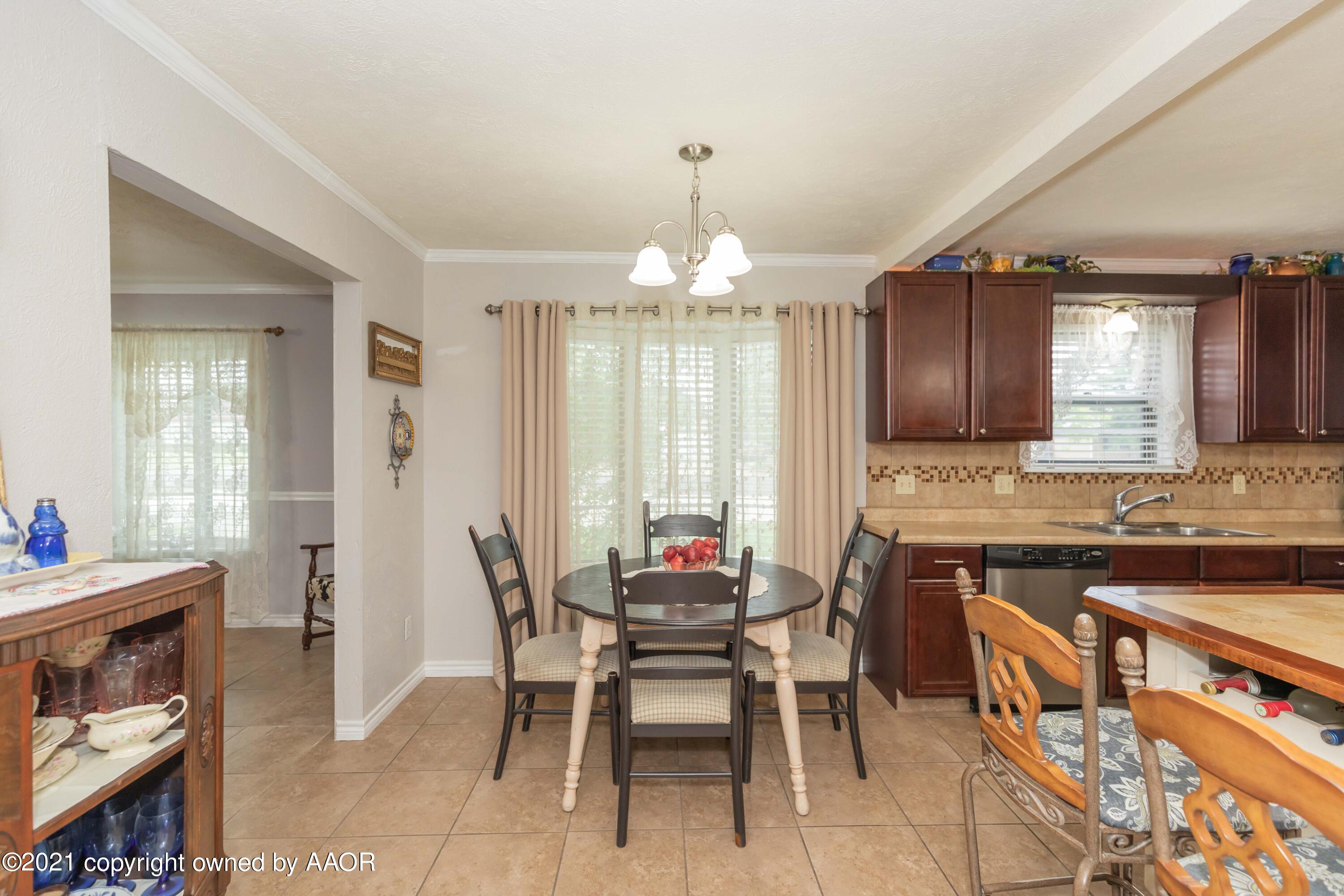 4707 Journey Street Amarillo, TX 79110 - Photo 19 of 65 a dining room with a table chairs and a kitchen view