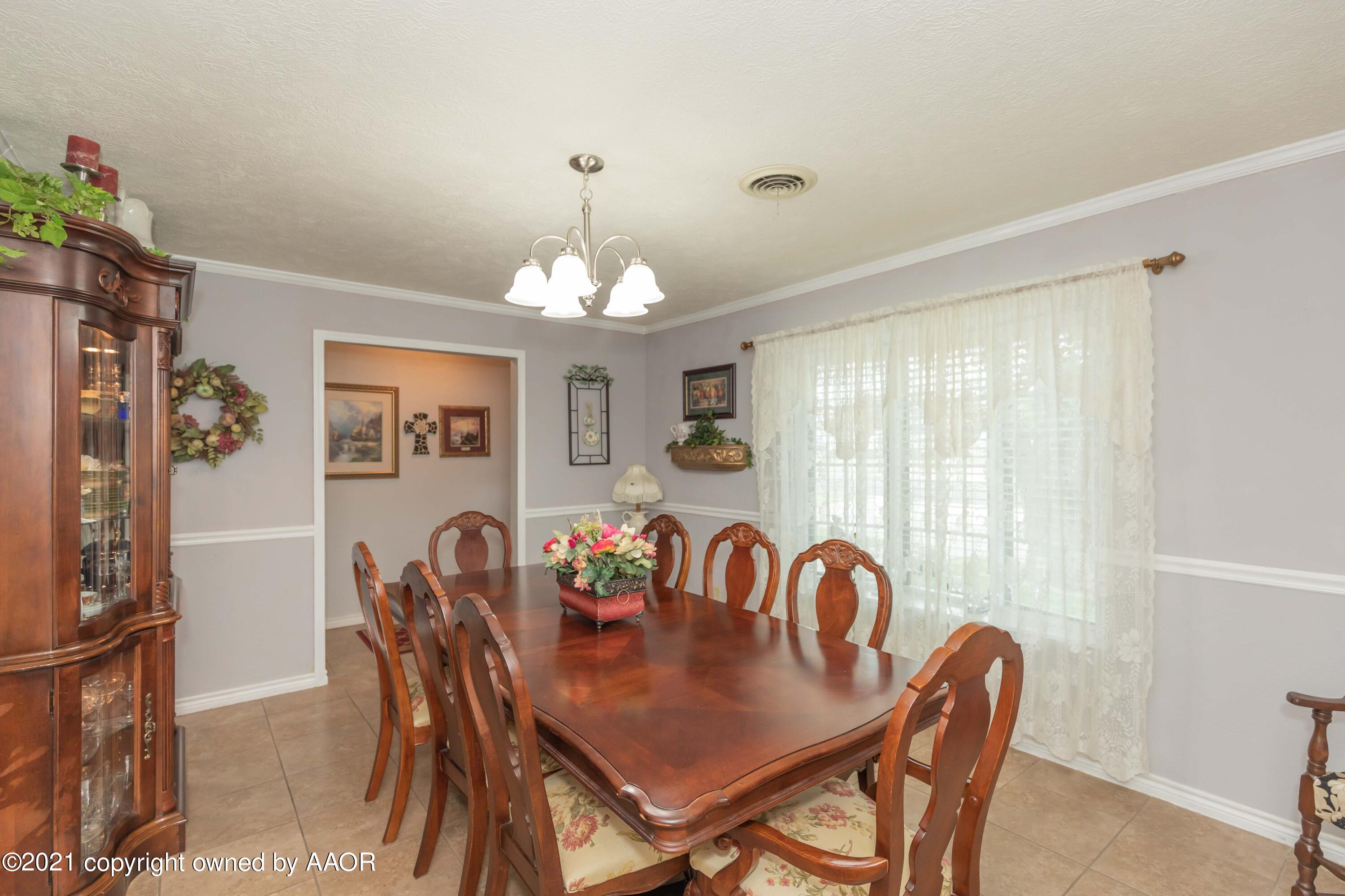 4707 Journey Street Amarillo, TX 79110 - Photo 21 of 65 a view of a dining room with furniture and chandelier