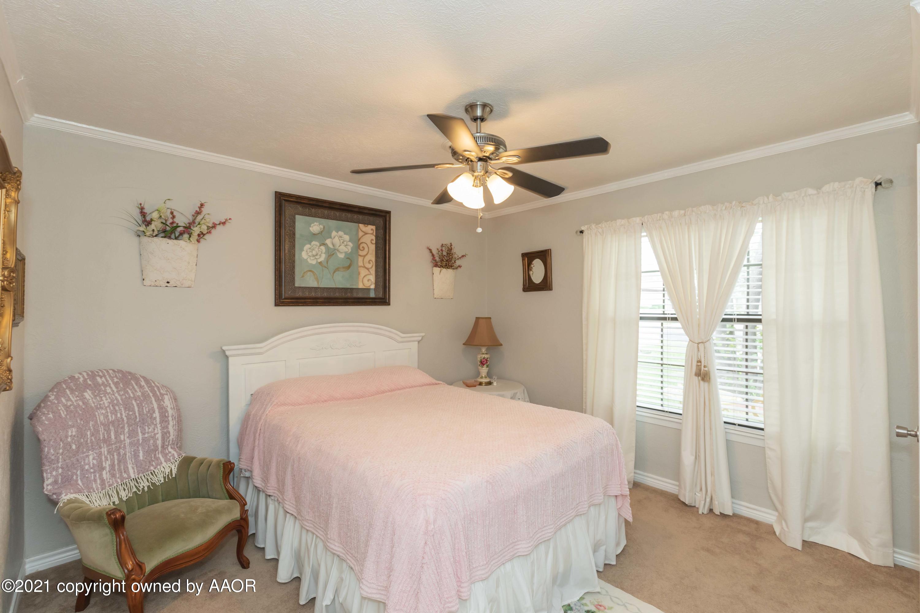 4707 Journey Street Amarillo, TX 79110 - Photo 29 of 65 a bedroom with a bed mirror and window