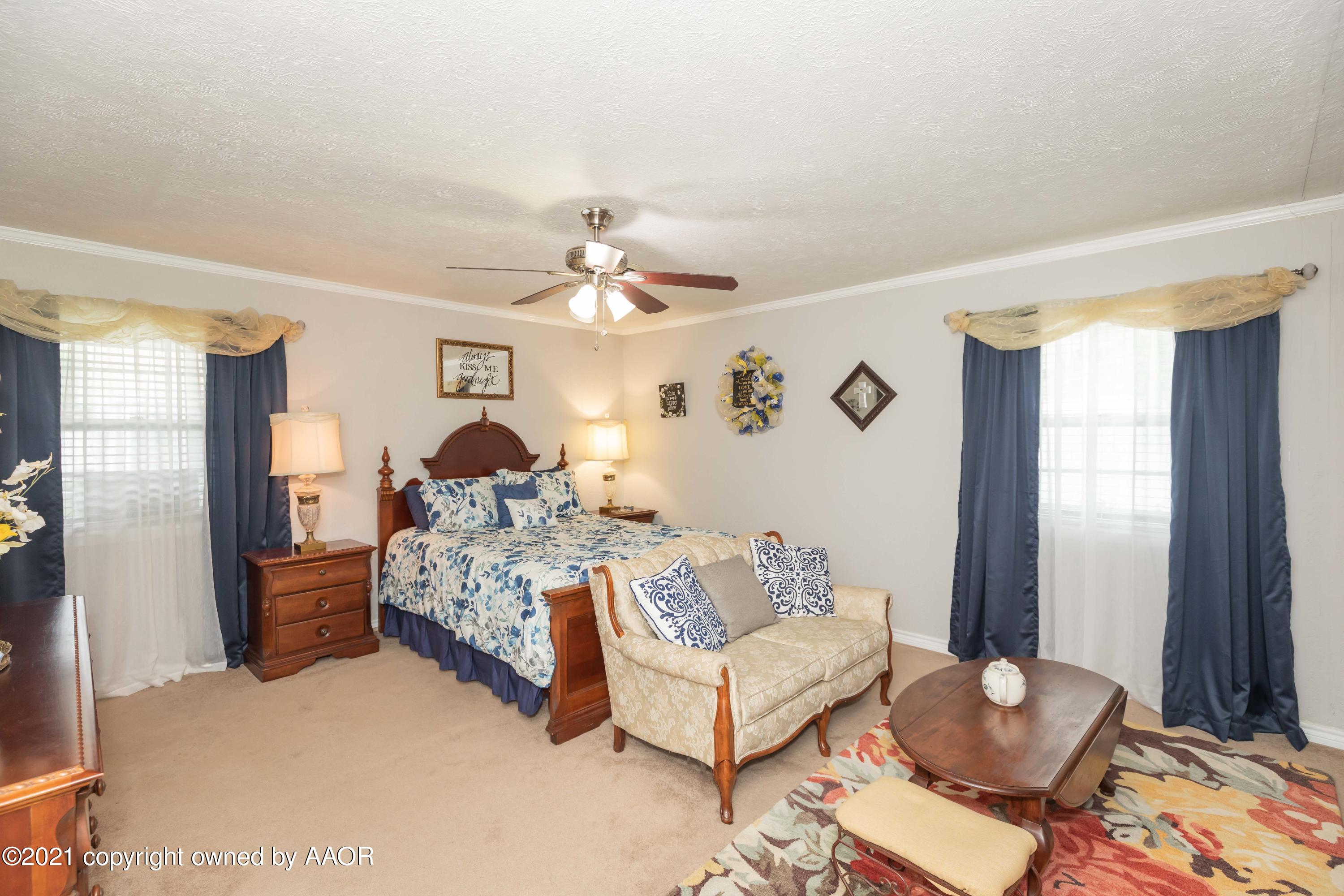 4707 Journey Street Amarillo, TX 79110 - Photo 32 of 65 a bed room with a bed and a chandelier