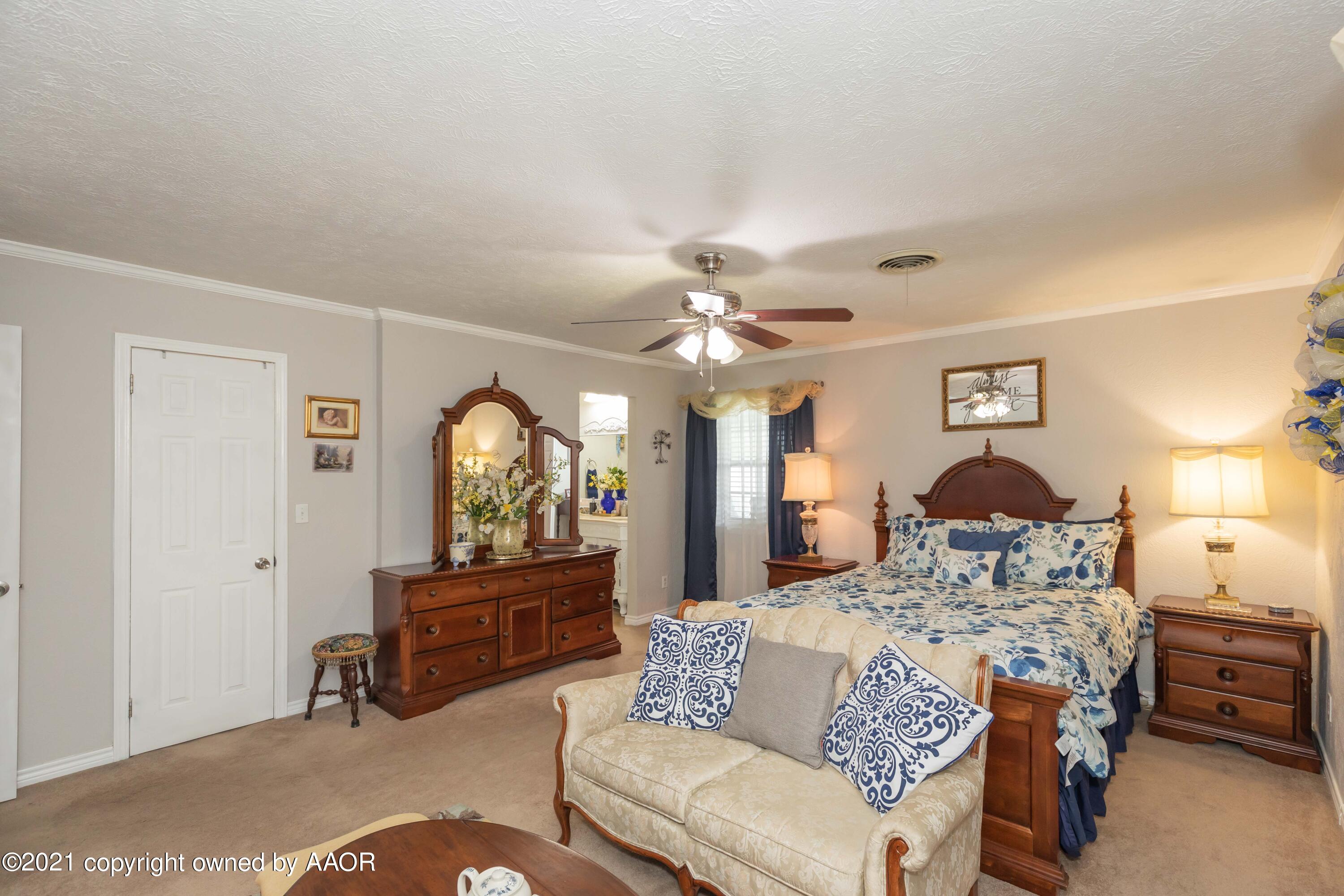 4707 Journey Street Amarillo, TX 79110 - Photo 33 of 65 a living room with furniture a chandelier and a window