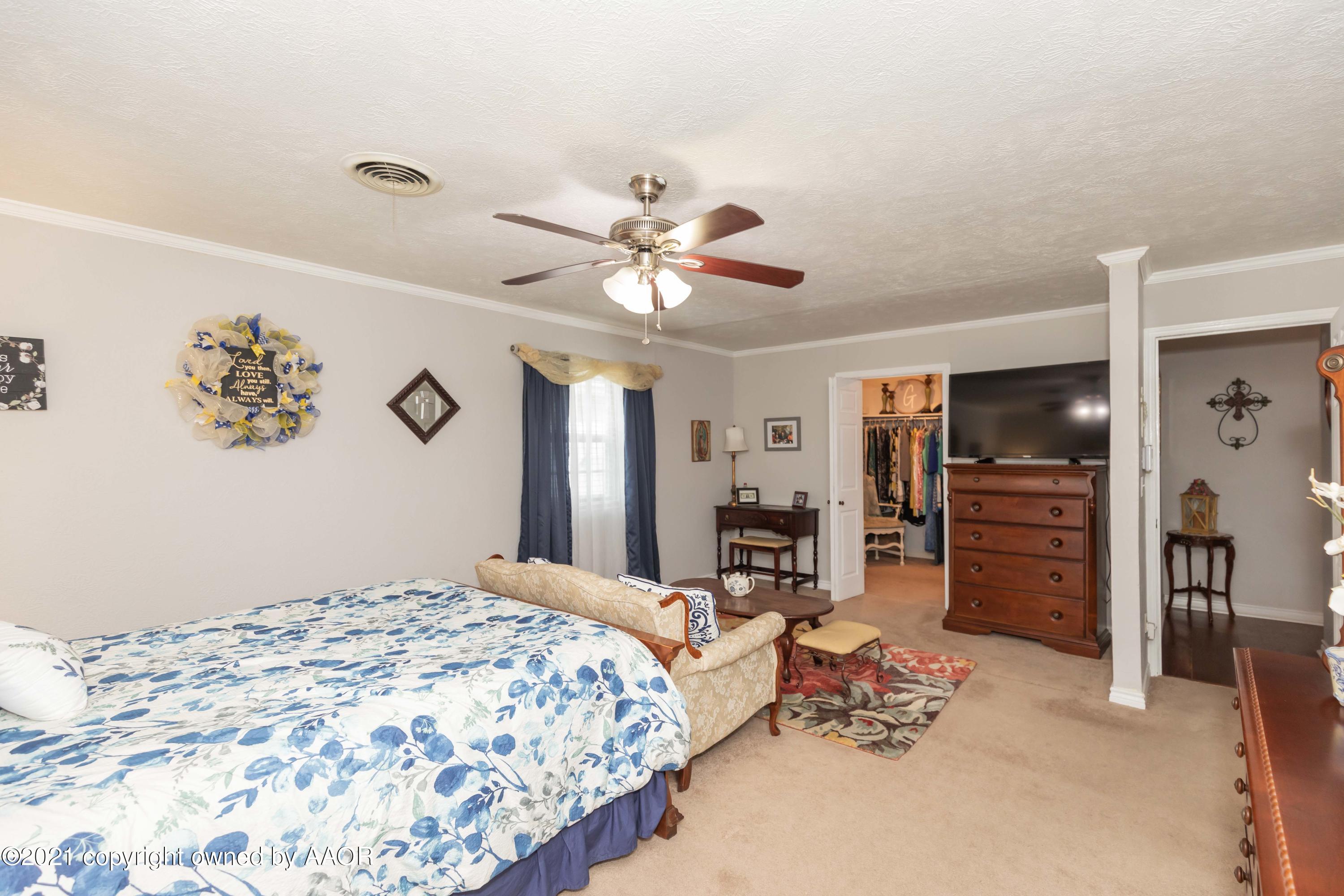 4707 Journey Street Amarillo, TX 79110 - Photo 34 of 65 a bedroom with a bed and a chandelier