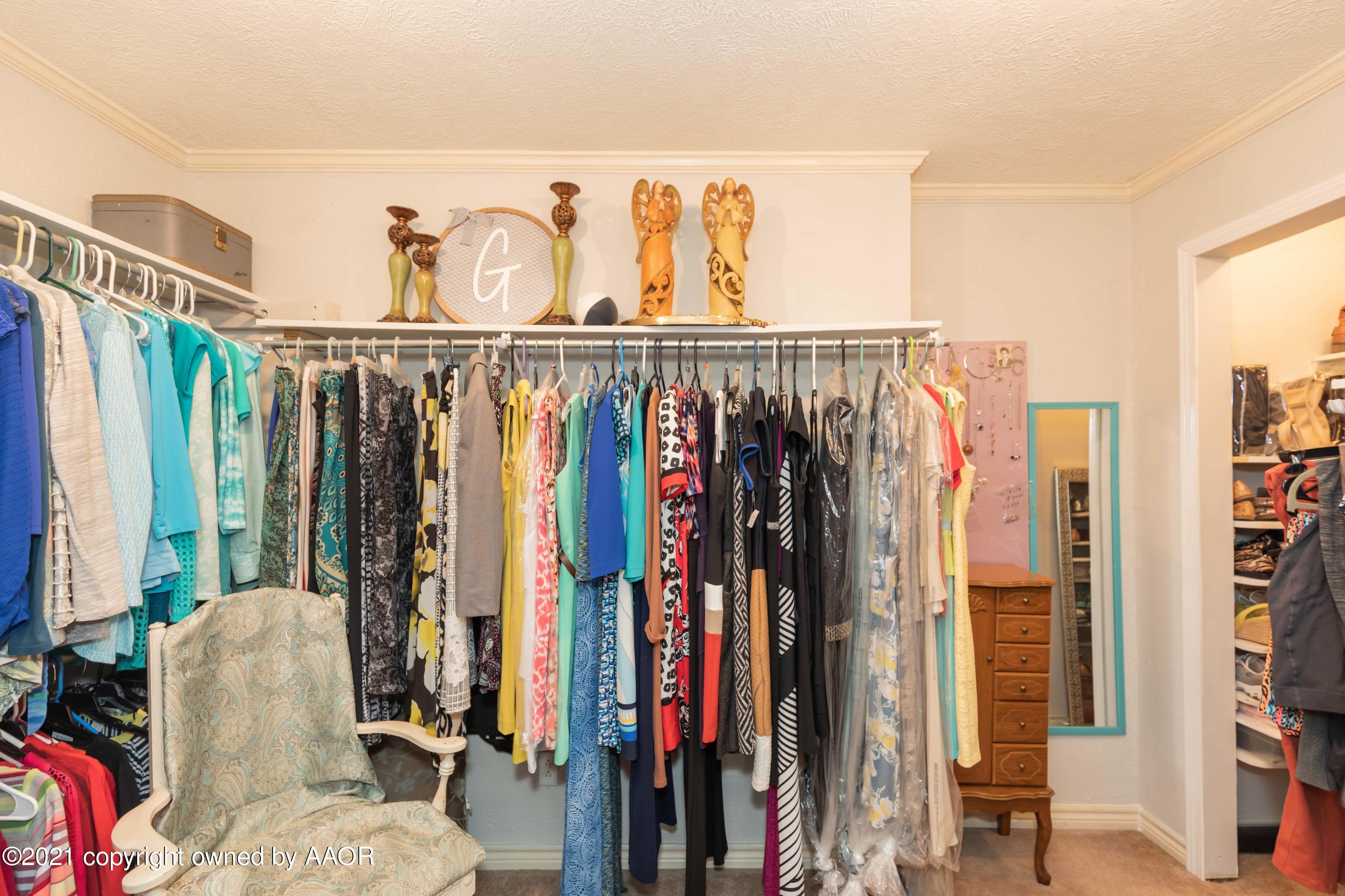 4707 Journey Street Amarillo, TX 79110 - Photo 35 of 65 a view of walk in closet with clothes and shoes
