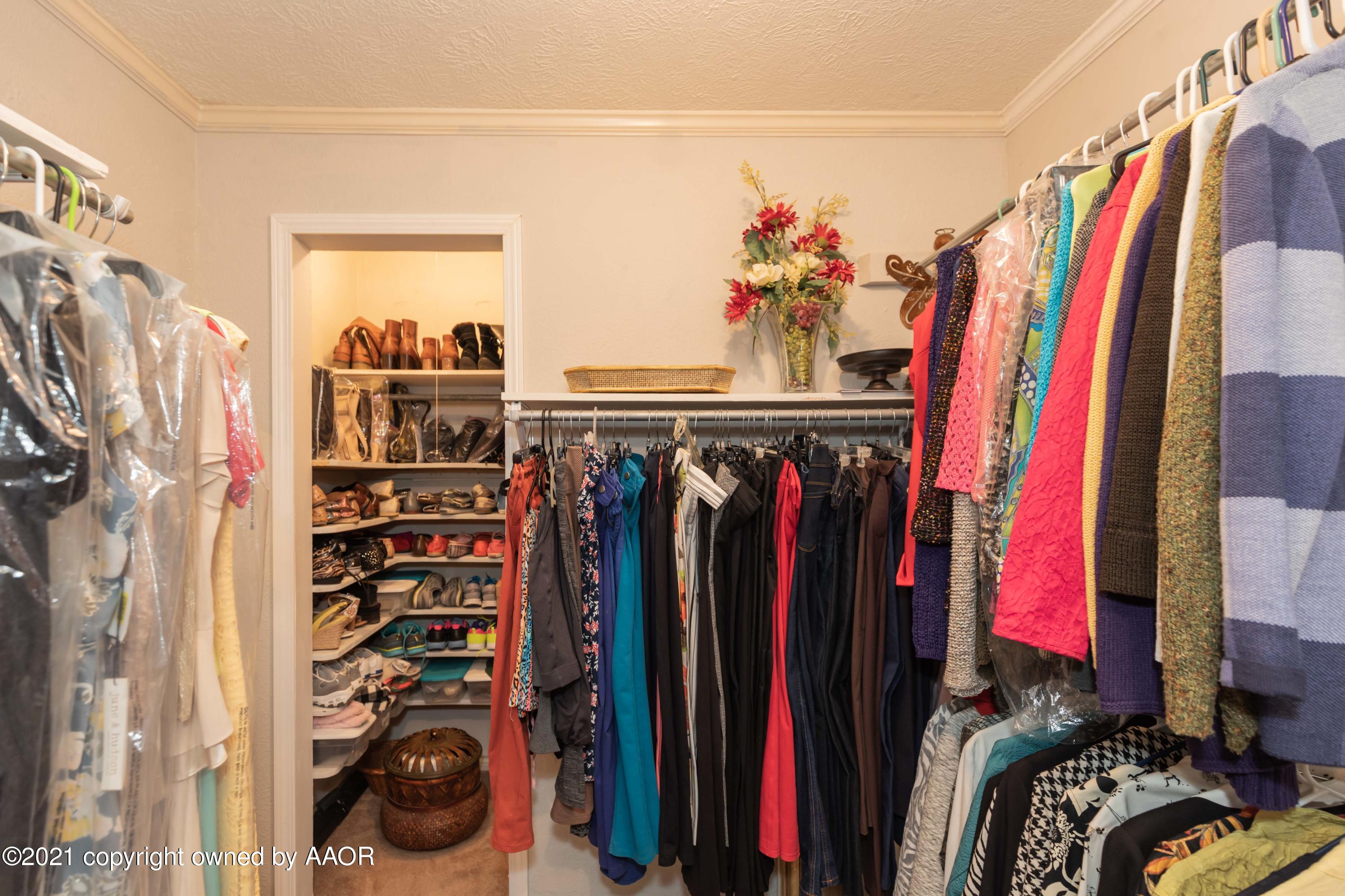 4707 Journey Street Amarillo, TX 79110 - Photo 36 of 65 a view of walk in closet with clothes and shoes
