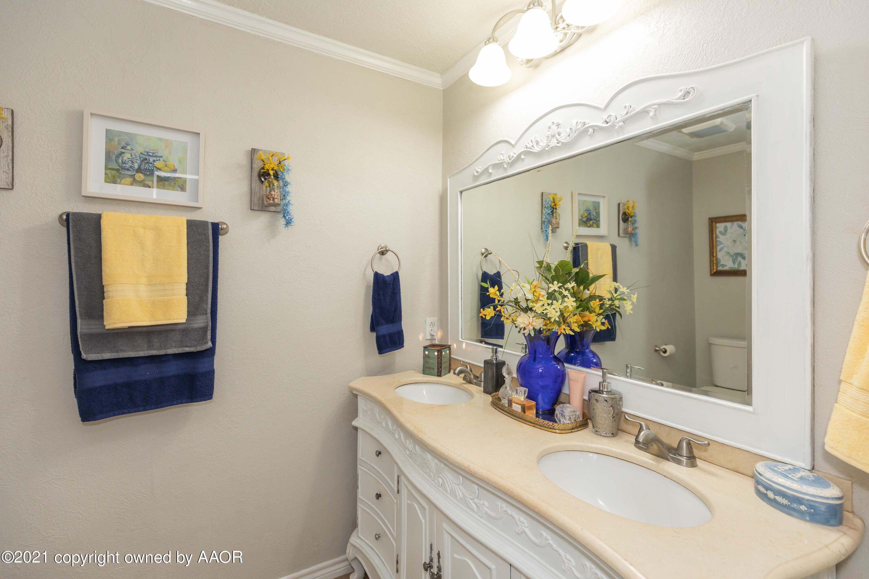 4707 Journey Street Amarillo, TX 79110 - Photo 37 of 65 a bathroom with a sink double vanity and a mirror