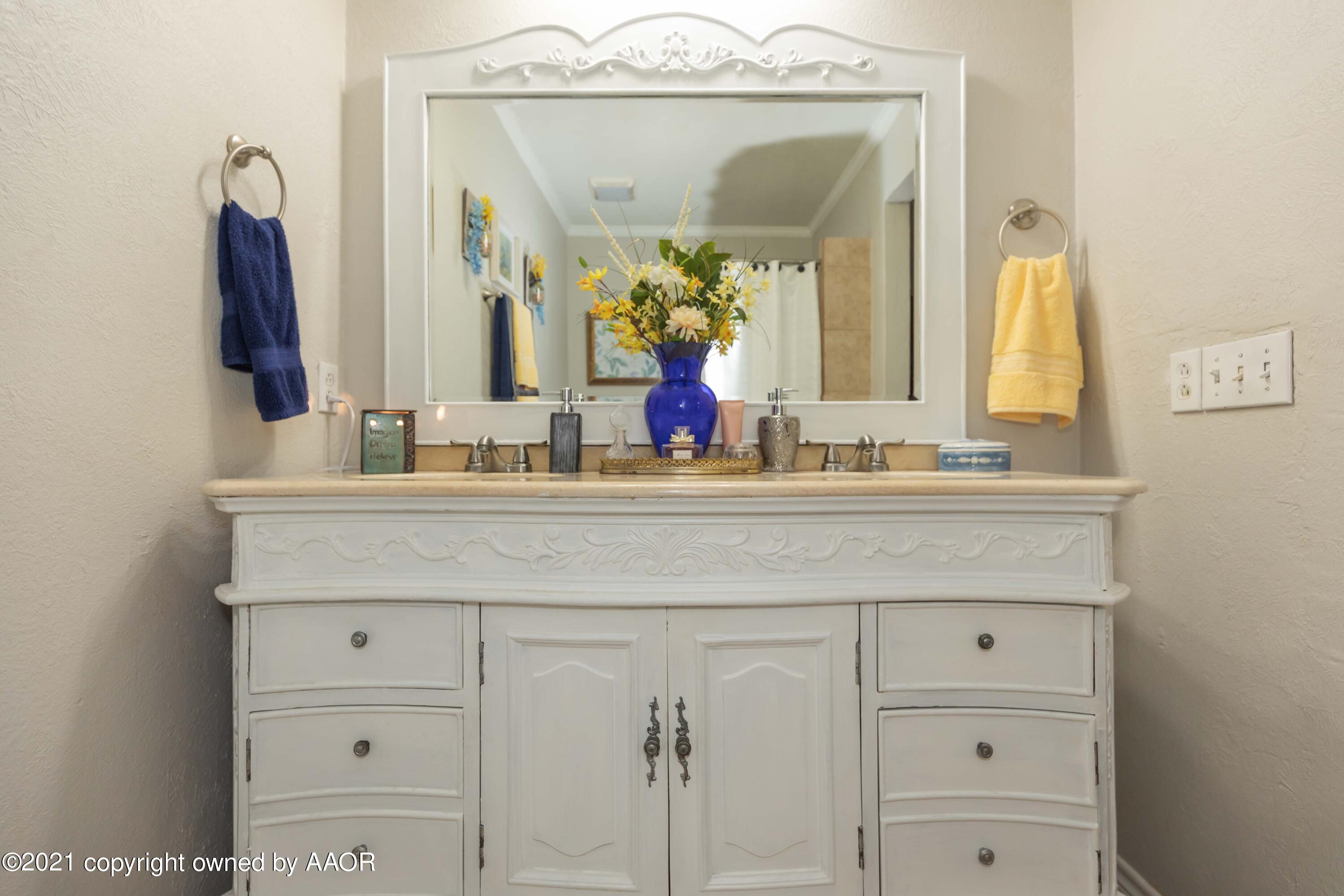4707 Journey Street Amarillo, TX 79110 - Photo 39 of 65 a bathroom with a sink vanity and a mirror