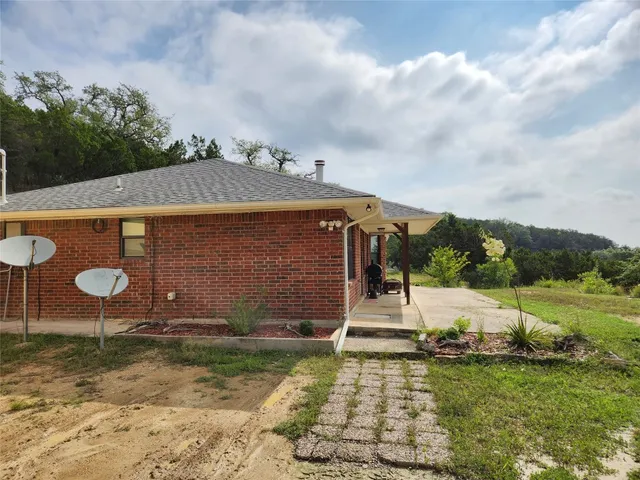 an aerial view of a house with yard