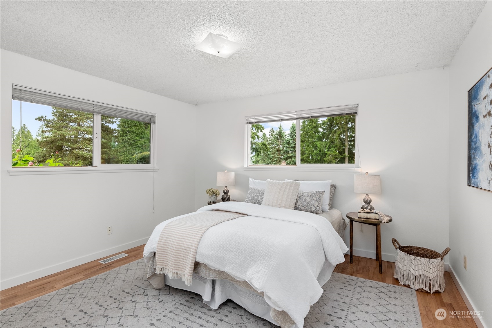 10616 Northeast 194th Street Bothell, WA 98011 - Photo 16 of 29 a bedroom with a bed and wooden floor