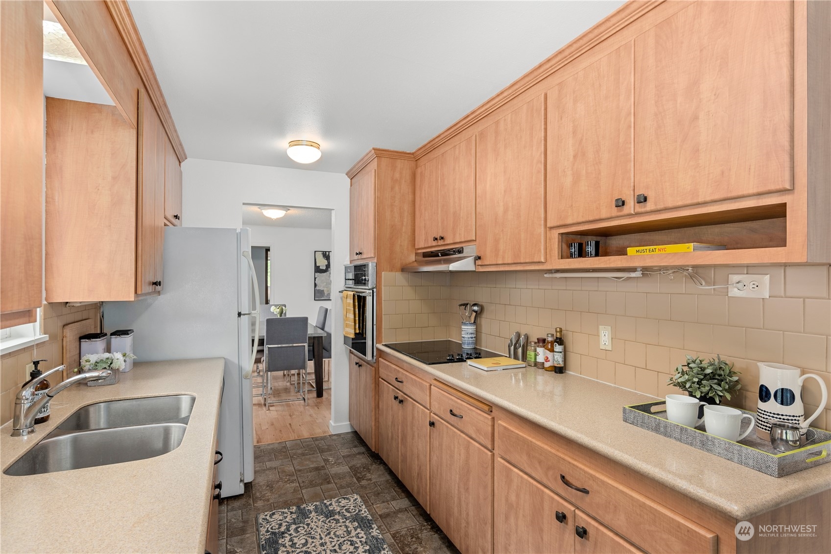 10616 Northeast 194th Street Bothell, WA 98011 - Photo 8 of 29 a kitchen with granite countertop a sink dishwasher refrigerator and cabinets