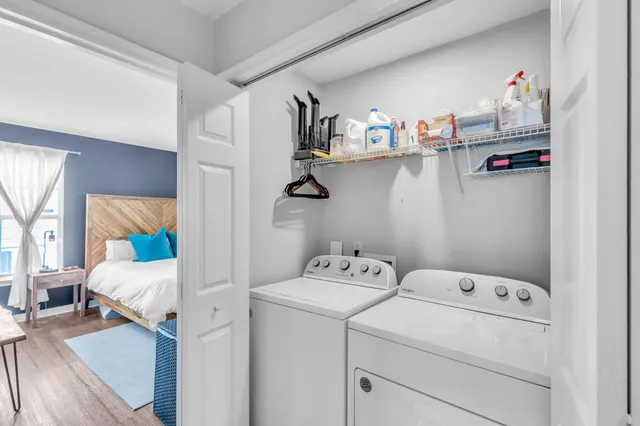 a bedroom with a bed and a wooden floor