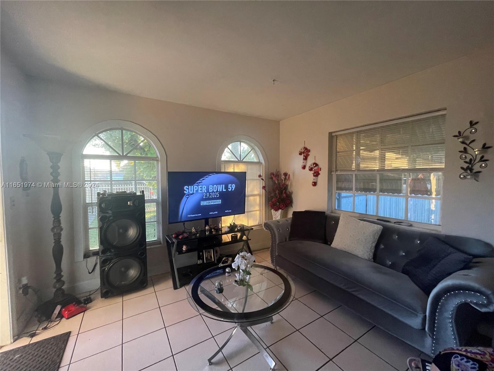 29361 Maine Road Homestead, FL 33033 - Photo 3 of 12 a living room with furniture a lamp and a large window