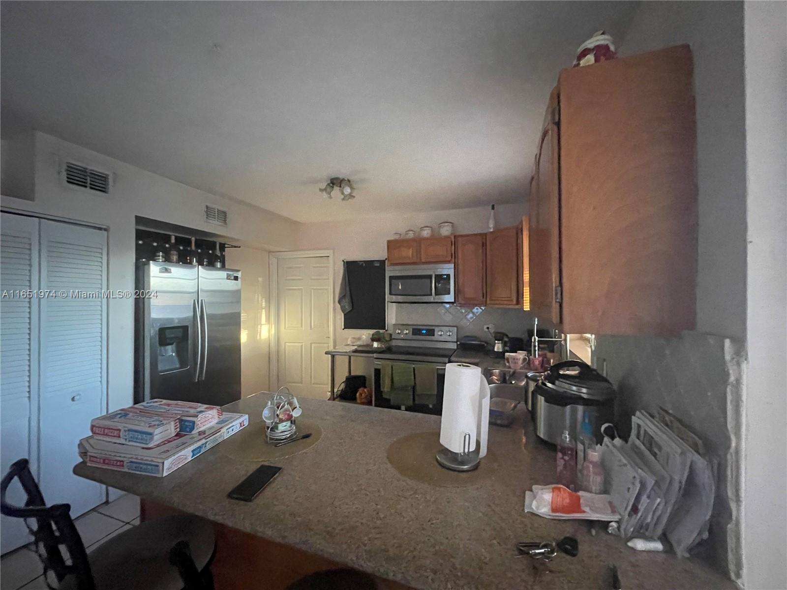 29361 Maine Road Homestead, FL 33033 - Photo 6 of 12 a kitchen with sink refrigerator and cabinets