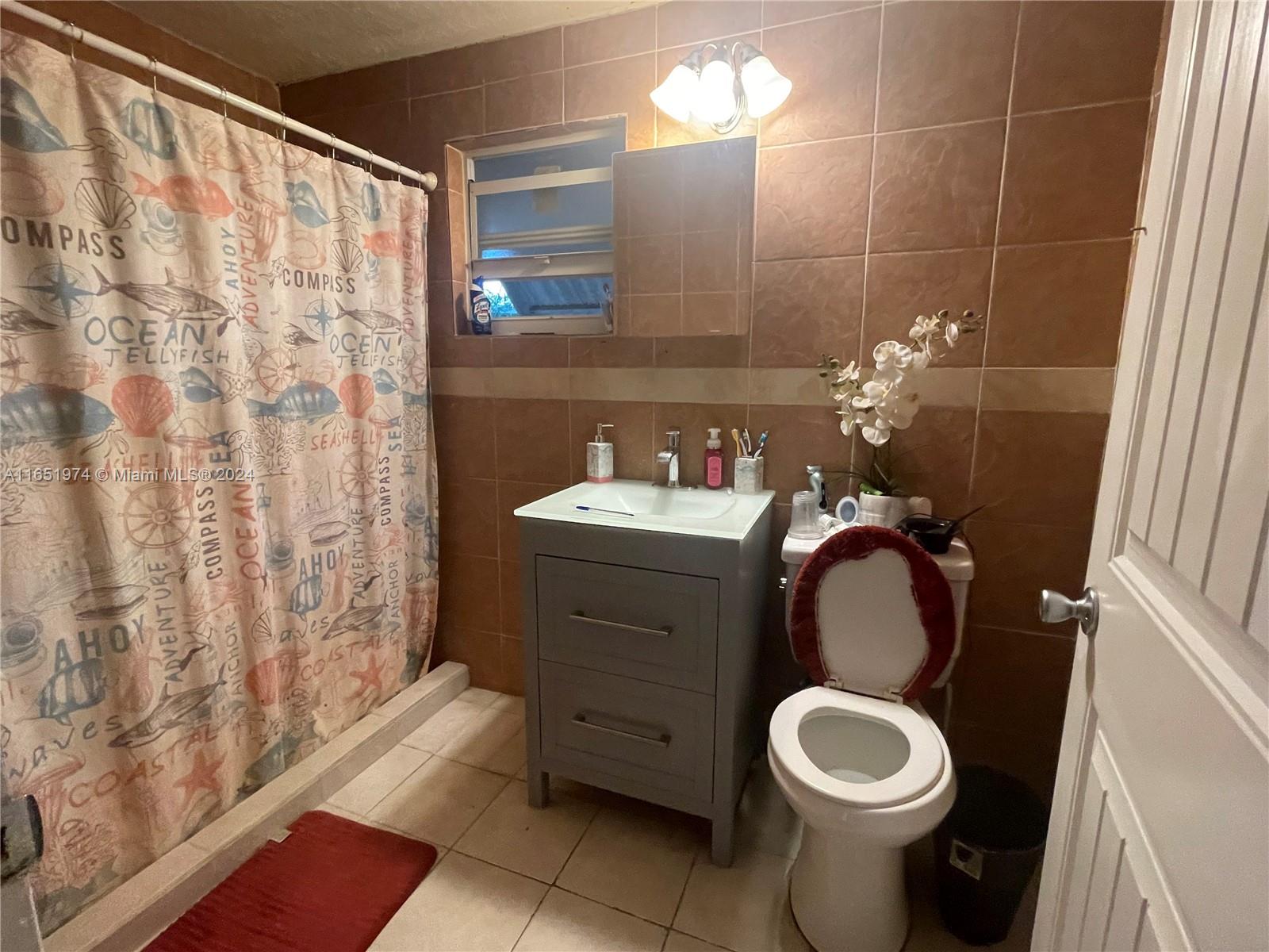 29361 Maine Road Homestead, FL 33033 - Photo 9 of 12 a bathroom with a sink toilet and shower