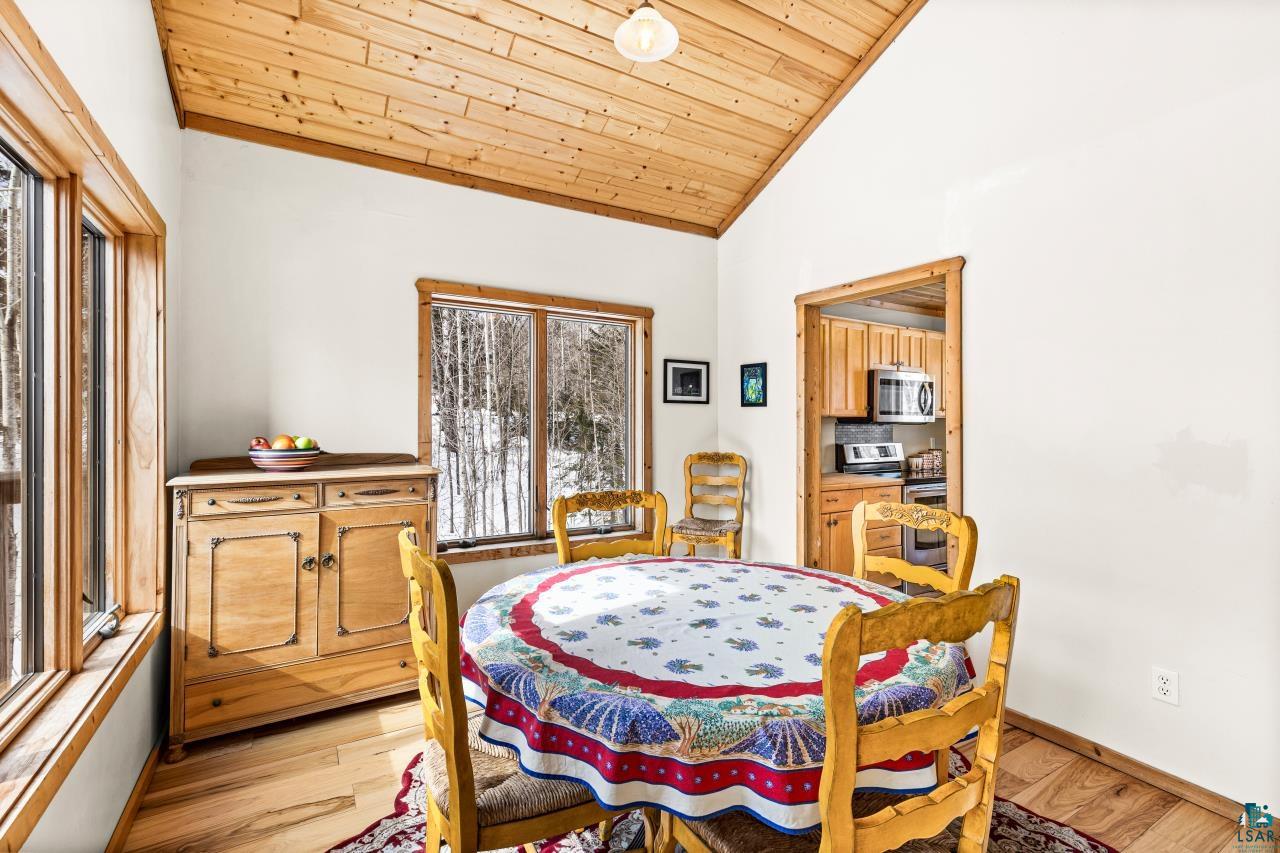 67 Snowshoe Trail Tofte, MN 55615 - Photo 21 of 42 Dining area featuring a vaulted wood ceiling and light wood-type flooring