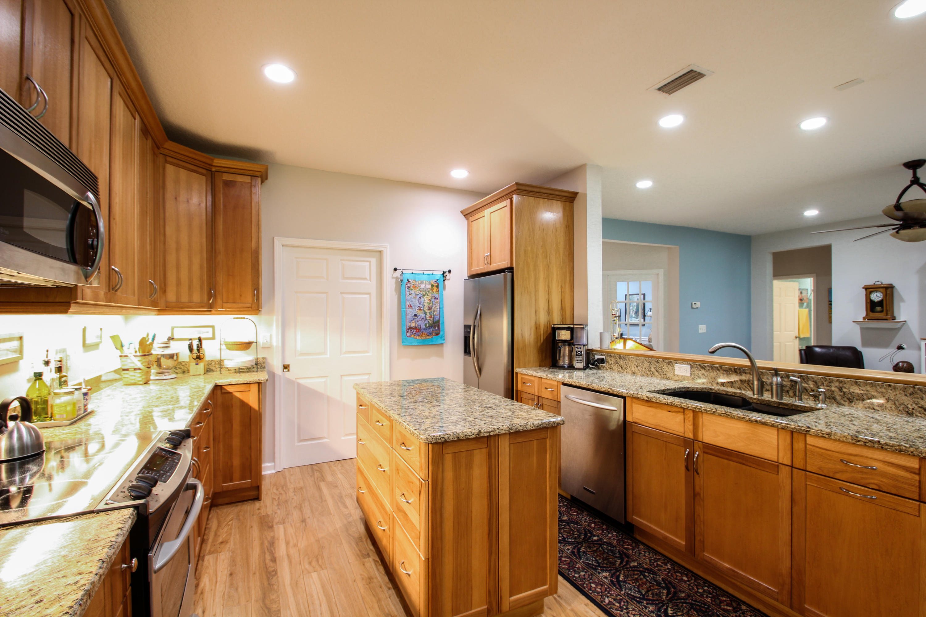 1386 Long Bay Road Middleburg, FL 32068 - Photo 14 of 40 a kitchen with lots of counter top space and living room