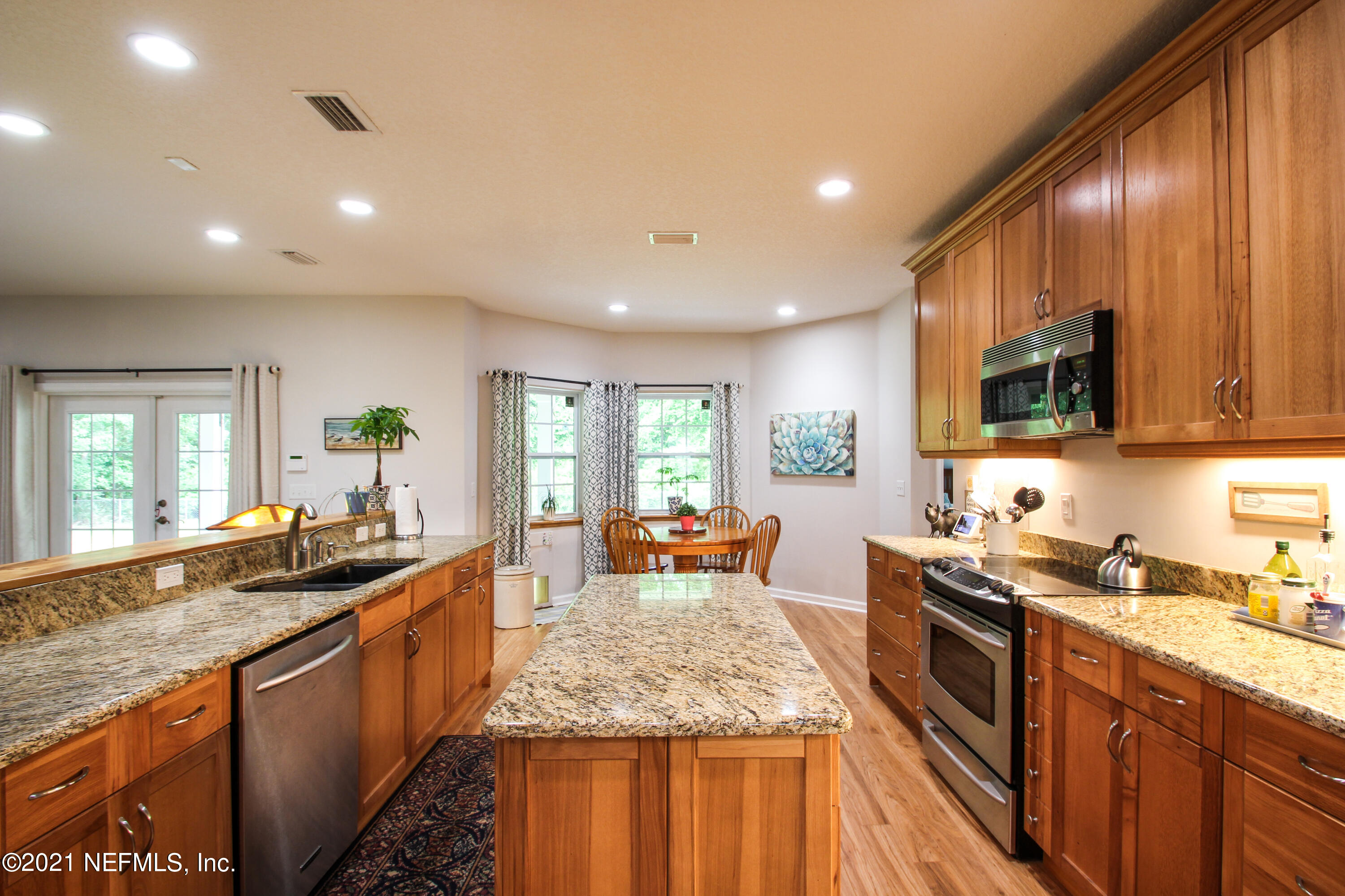1386 Long Bay Road Middleburg, FL 32068 - Photo 15 of 40 a large kitchen with granite countertop lots of counter space sink and a large window