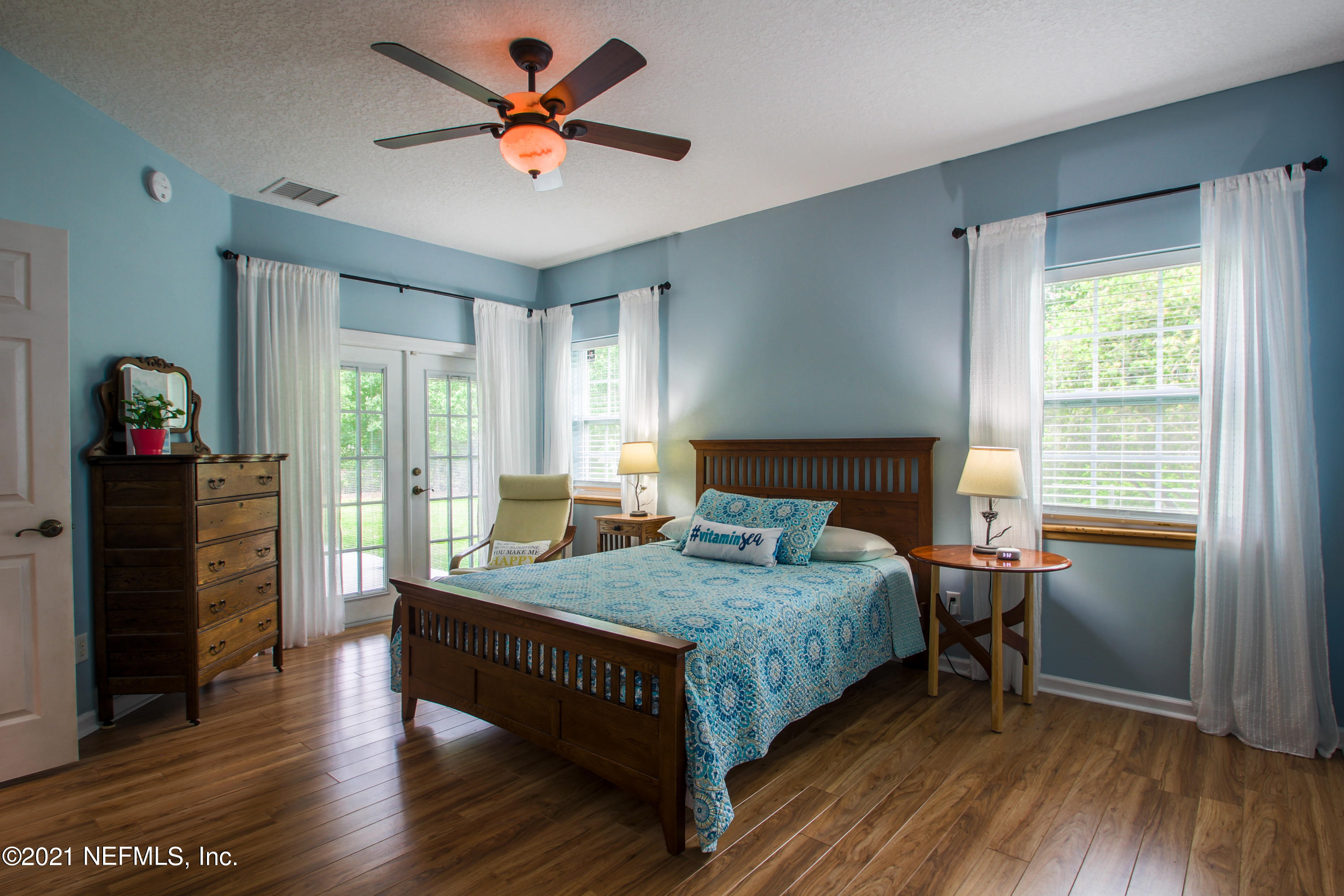 1386 Long Bay Road Middleburg, FL 32068 - Photo 19 of 40 a bedroom with a bed and a table in it