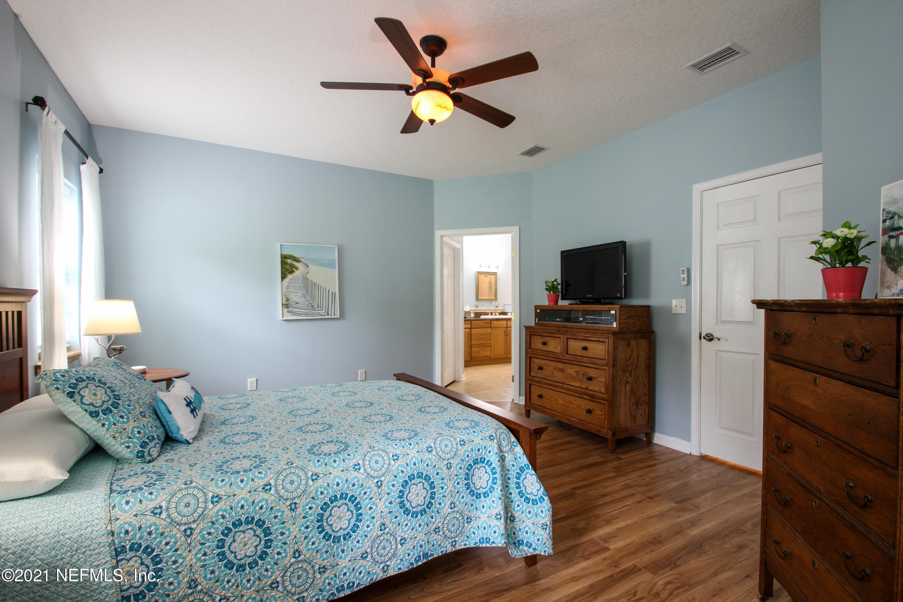 1386 Long Bay Road Middleburg, FL 32068 - Photo 20 of 40 a bedroom with a bed and a flat screen tv