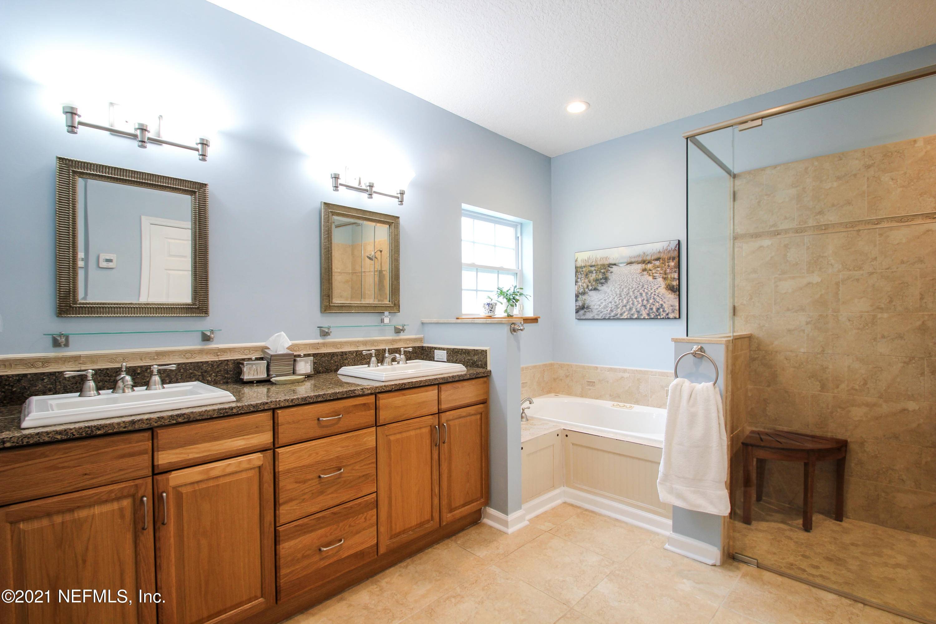 1386 Long Bay Road Middleburg, FL 32068 - Photo 22 of 40 a spacious bathroom with a double vanity sink a mirror and a bathtub