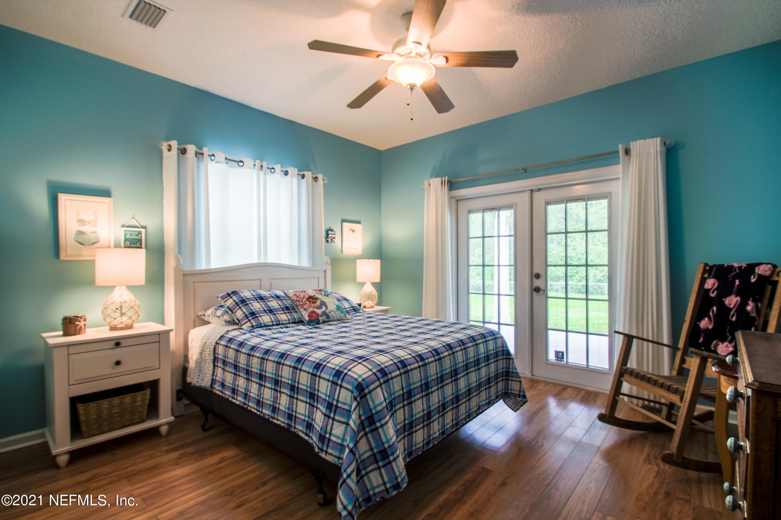 1386 Long Bay Road Middleburg, FL 32068 - Photo 26 of 40 a bedroom with a bed and a chandelier