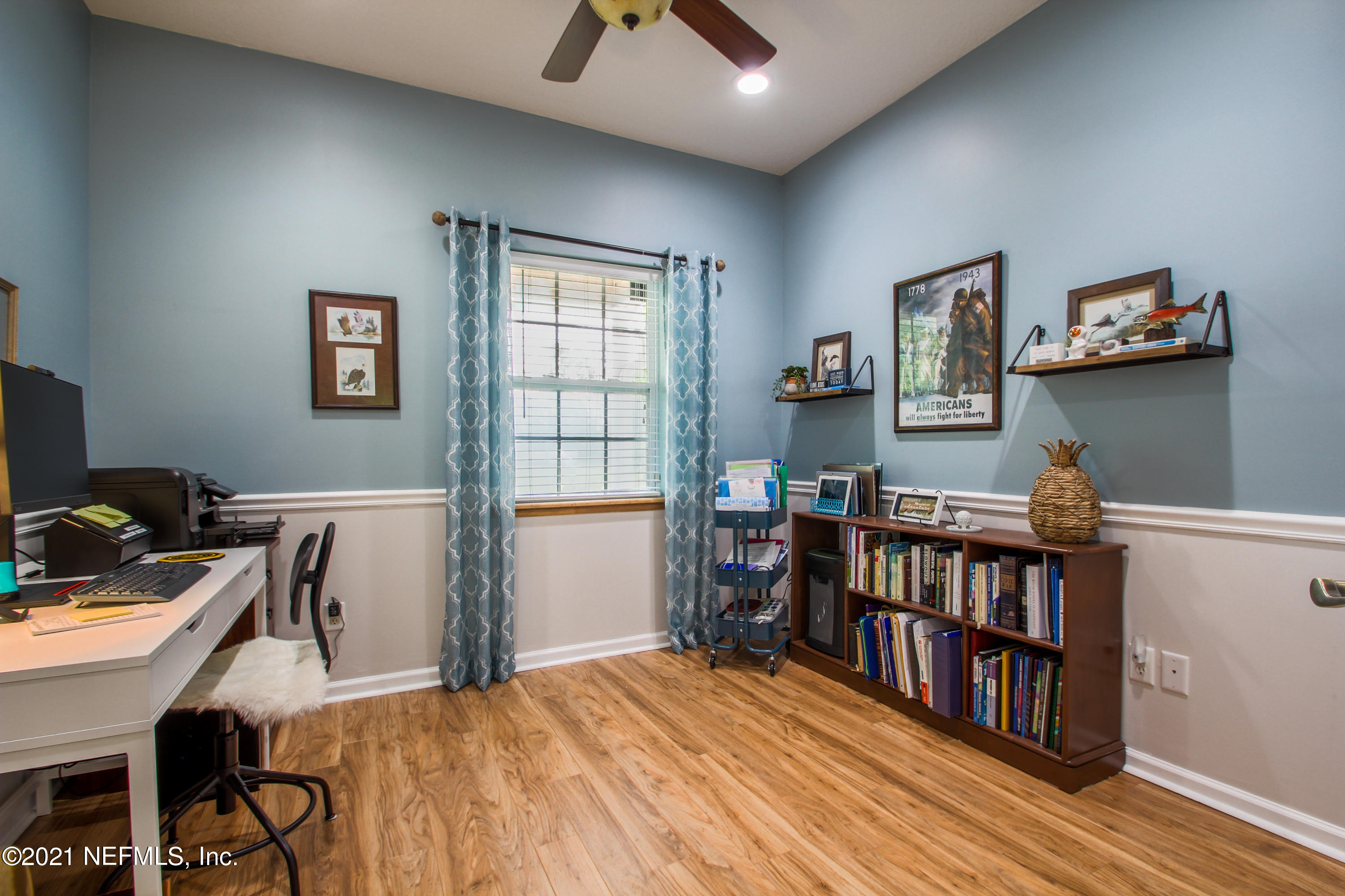 1386 Long Bay Road Middleburg, FL 32068 - Photo 30 of 40 a view of a workspace with furniture and a book shelf